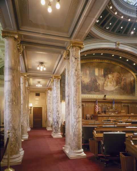 Two rows of columns, carved of Frenche breche marble, provide a stately passage between the Assembly Chamber and the Assembly Loggia, along the exterior wall in the Wisconsin State Capitol.