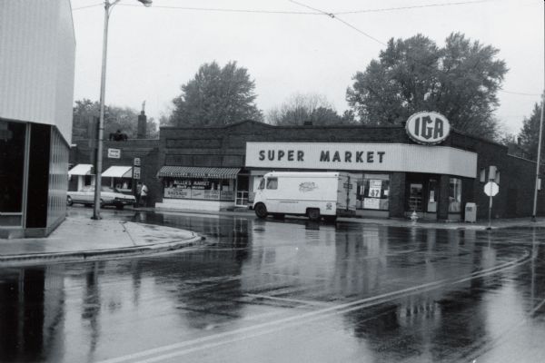On a rainy day a Gardners' Bakery truck makes a delivery to Miller's Corner IGA Grocery Store on STH 153.