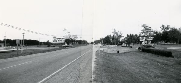 Panoramic view of the intersection of CTH Z and STH 13 near Wisconsin Rapids.  A billboard to the left advertises the Ridges Inn and Country Club; on the right is the sign for Lazy Acres Motel.