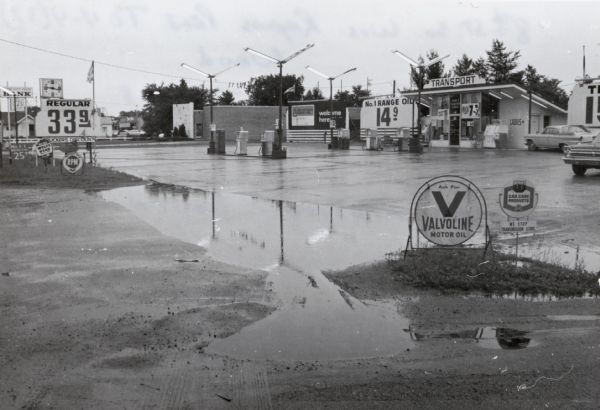 Transport gasoline station on 8th Street (STH 13) in Wisconsin Rapids, looking northeast. A sign advertises regular gasoline for sale for 33 cents per gallon.