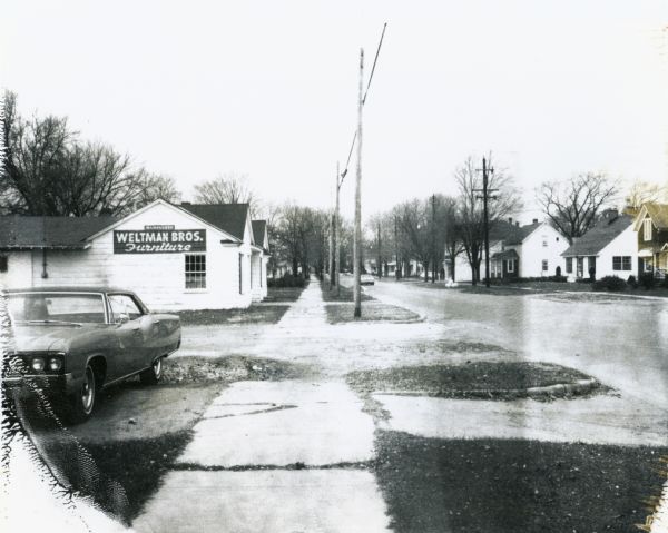 Town Line Road in Wausau, looking west, toward a residential neighborhood.  On the left is the Weltman Furniture store which also appears in Image 36020.