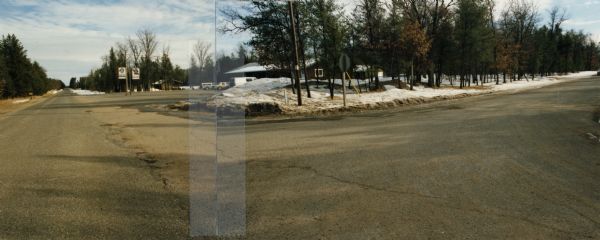 Panoramic view of the intersection of county highways Z (15th Avenue) and D in rural Adams County, looking east and south to a bar at the corner.