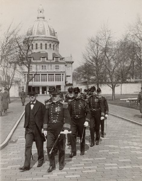 Parade of U.S. Naval Academy officers in full dress uniform prior to the graduation of the Annapolis midshipmen, showing Secretary of the Navy Josephus Daniels and Captain Edward Eberle.  The chapel can be seen in the background.