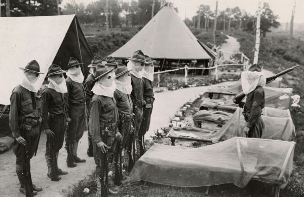 For these World War I recruits seen at an unidentified training camp on Long Island, the enemy was not the Germans, but ferocious "Jersey mosquitos" and the protective gear they are wearing are bug screens, not gas masks.