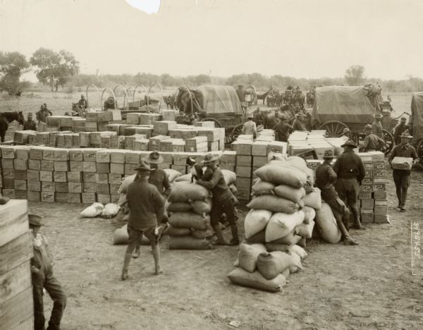 American soldiers unpacking supplies at the Casas Grande, Mexico, the field headquarters of the military force sent to capture Pancho Villa. The supplies were shipped to that point by wagon train from Columbus, New Mexico.