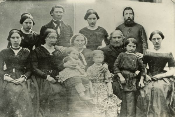 Portrait of the Siggelkow Family of copied from a lost daguerreotype. In the back row from left to right are Augusta Scharlotte, Johann Adolph, Marie Louise, and Wilhelm. In the bottom row from the left are Christine, Anna Sophie, mother Sophia with Richard Wilhelm on her lap, Elise, father George Adolph, Johann (John) Heinrich, and Louise Elise.