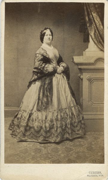 Full-length portrait of Eugenia Weed Smith, the wife of George B. Smith, a former mayor of Madison, prominent Democratic party leader, and attorney.