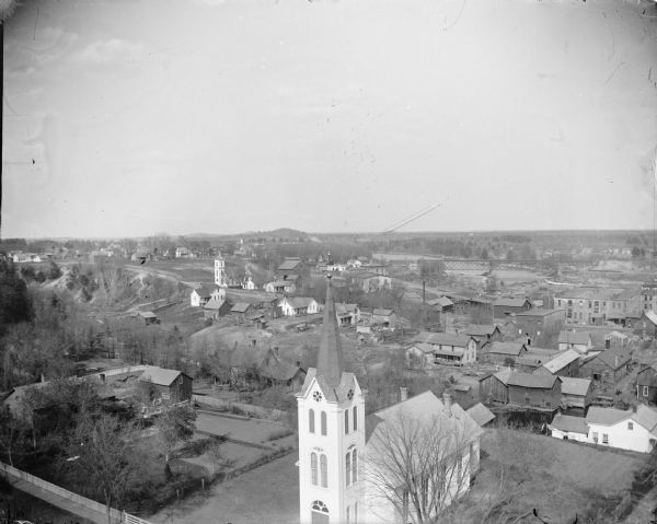 Elevated view of from the County Court House. Front center is the Evangelical Lutheran Church. Left middle ground is the first Roman Catholic Church with the white cross on top.