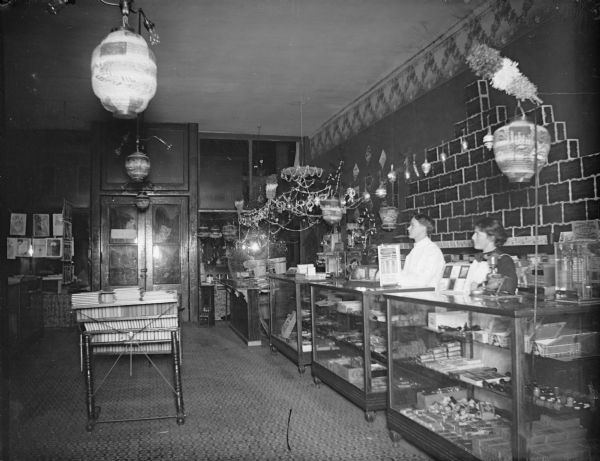 Interior of a store with clerks behind a novelty counter.