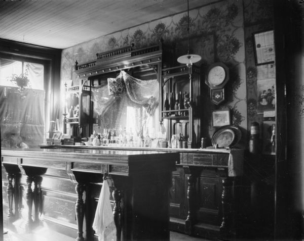 Interior of a tavern showing a bar and back counter.