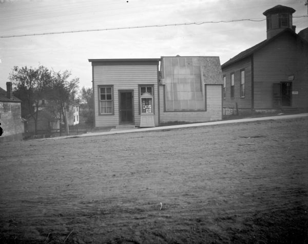 A. (Annen or Arnen) J. Roiseland's photograph gallery, opposite the Jackson County Court House, with a display case outside it. The City Library is to the right, once the Norwegian Church.