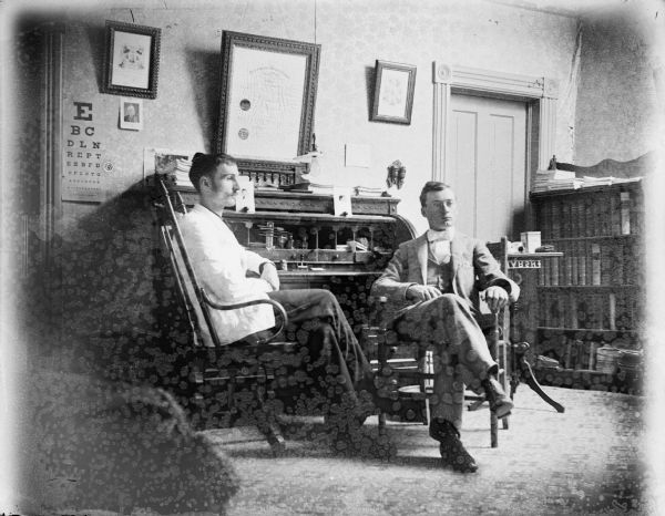 Two young men seated in a doctor's office, possibly Irwin and Robert Krohn.