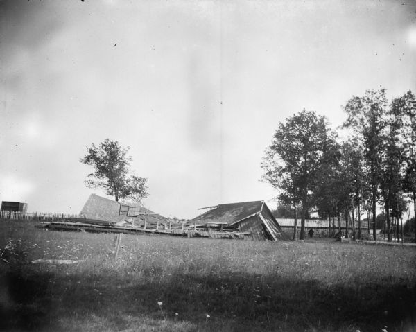 Collapsed wooden building, possibly at the Jackson County Fairgrounds, probably due to a tornado.