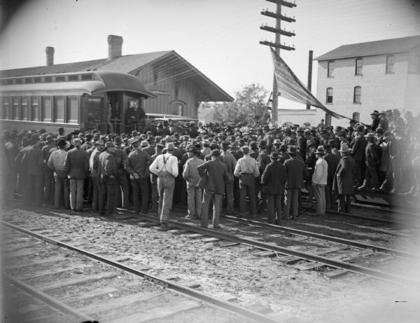 Crowd at station listening to a whistle-stop speaker at the railroad station, probably William McKinley.