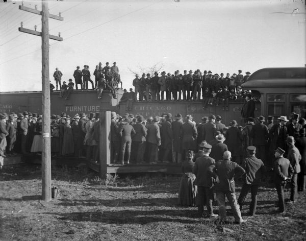 Crowd at station listening to a whistle-stop speaker at the railroad station, possibly Taft.