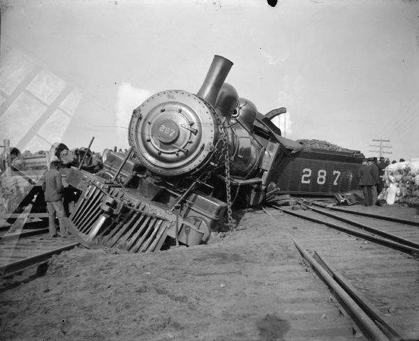 Derailed locomotive and coal car. Wreck on the Chicago, St. Paul, Minneapolis, and Omaha Railway, locomotive #287, in the vicinity of Black River Falls.