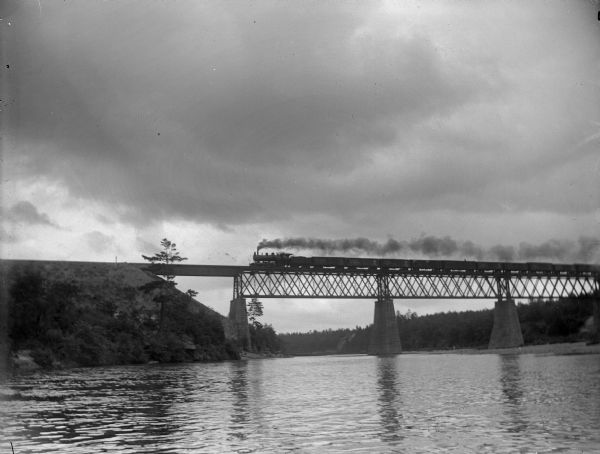 Freight train crossing river on a bridge north of Black River Falls.