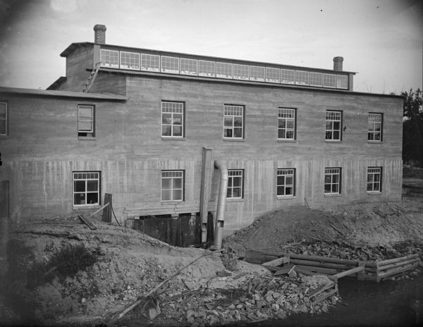 McGillivray Sash and Door Company, located on an island south of Harrison Street. The plant had a right to some of the water power. In the front is the tail race for that power. Built after a fire in the summer of 1912.