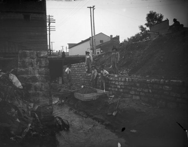 Men working on the passage of Town Creek under First Street, one-half block north of Main Street.