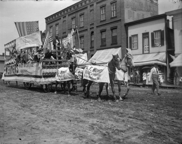 Horse-drawn float in parade promoting A.F. Werner, a local drugstore.	