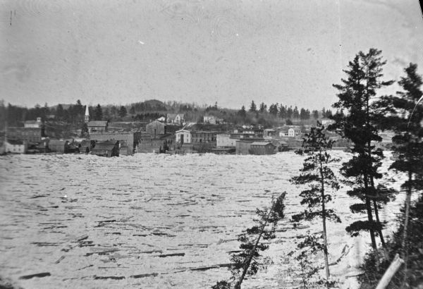 Log jam on a high-water river, probably the Ice Gorge of 1876.