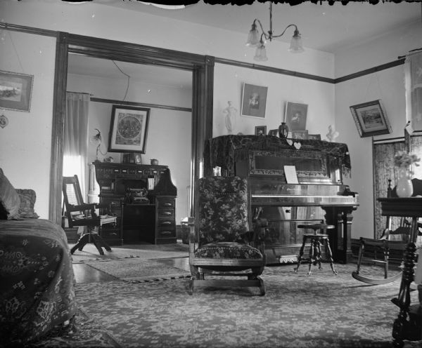 Interior with piano and a typewriter on a desk.