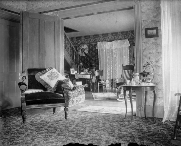 Interior of living room/parlor, hall, and staircase.