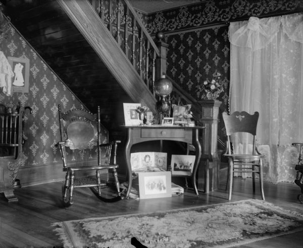 Interior of a staircase and table with photographs.
