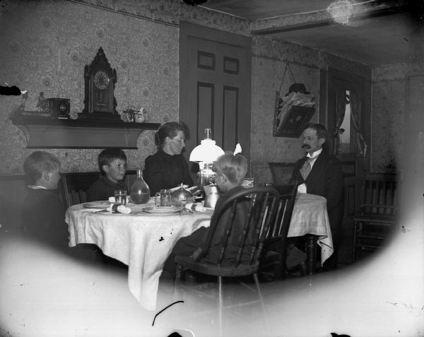 Charles J. Van Schaick and his family at the dinner table. He had three sons; Shirley, born 1885, Roy, born 1887, and Harold, born 1889. Both husband and wife taught school. Shirley became a bookkeeper with the American Express Company in Milwaukee, and Roy and Harold both became medical doctors, the former retired in Jacksonville, Florida.