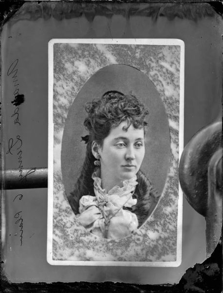 Copy photograph of a studio portrait of a young woman. Etching on negative says, "Amanda Lenny 6 Plain."
