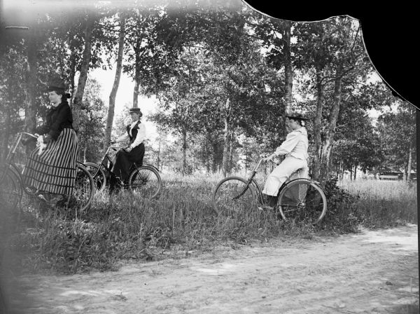 Three women riding bicycles.