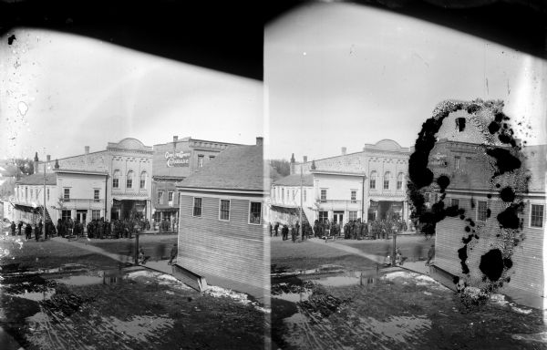 Elevated view of crowd gathered at the intersection of First and Main Streets. Probably taken from the window of the Van Schaick studio. A dual view, possibly a stereograph.