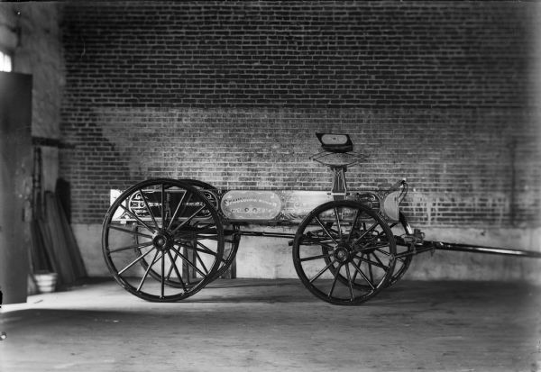 A highly decorated Spaulding Wagon is parked in the interior of a brick building.