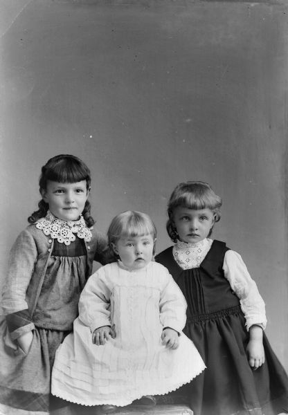 A studio portrait of three young girls.