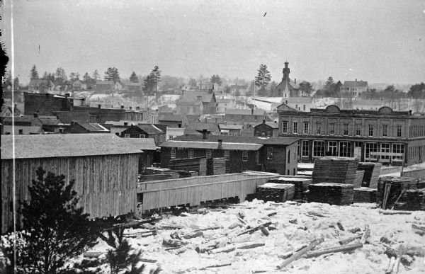 A view of the lumberyard with the town in the background.