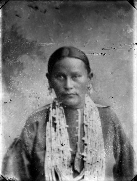 Waist-up copy photograph of a studio portrait of Ho-Chunk woman wearing bead necklaces and earrings, probably the wife of Dr. Bill Thunder and the mother of Kate Miner, who reportedly originally came from Nebraska.