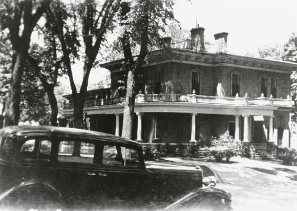 View from 121 East Gilman Street, of Annie S. Brown's Franklin car. In the background is the Governor's residence.