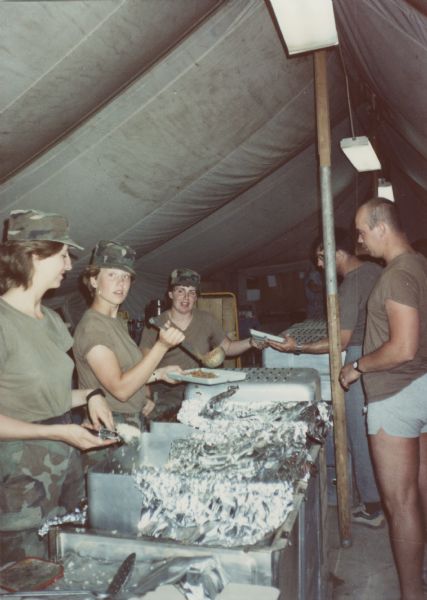 Interior of a mess tent in Saudia Arabia with soldiers in line for food during the Persian Gulf War.