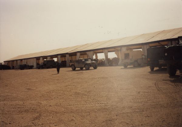 Mail point in Saudi Arabia during the Persian Gulf War including many Humvees and 6x6 trucks.