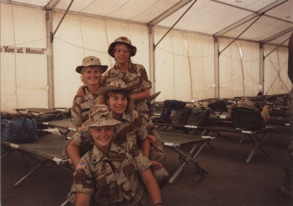 Sue Drabek, [Unidentified], Stacy Jalowitz, and [Unidentified] pose together just prior to leaving Saudi Arabia after serving in the Persian Gulf War.