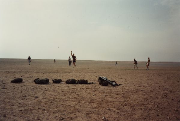 Soldiers playing softball in the desert during the Persian Gulf War.