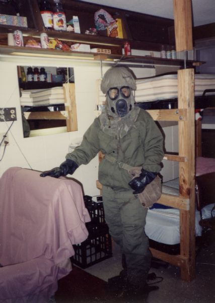 Stacy Jalowitz in MOPP (Mission Oriented Protective Posture) #4 suit, including gas mask, during the Persian Gulf War.