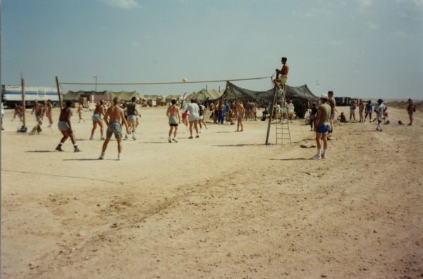 Soldiers playing volleyball in the desert during the Persian Gulf War.