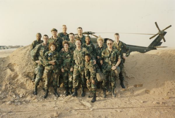 Members of the pharmacy section in front of a Blackhawk helicopter during the Persian Gulf War.
