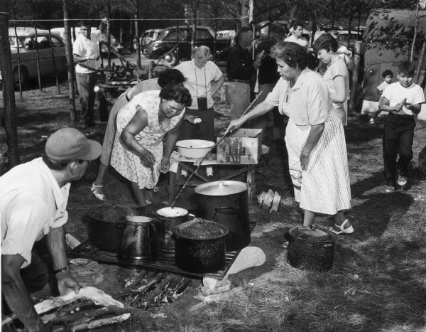 Women make fry bread at the dedication of the Winnebago Indian Village.