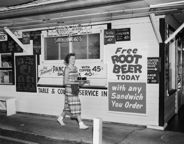 Newman's Drive-In with Free Root Beer sign and waitress.