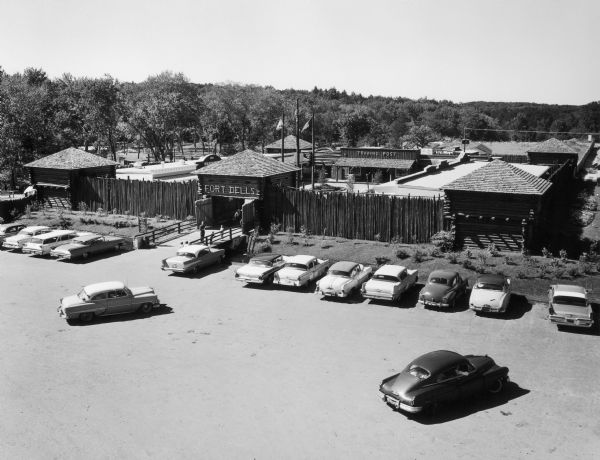 Elevated view of the entrance to Fort Dells with cars parked in parking lot.