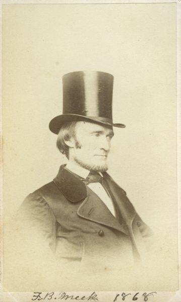 Carte-de-visite portrait of Fielding B. Meek (1817-1876), American paleontologist. Meek became the Smithsonian Institution's first full-time paleontologist in 1858. Died of tuberculosis December 21, 1876. Shown here sitting in three-quarter profile, wearing a top hat.  Handwritten inscription at bottom reads, "F.B.Meek 1868."