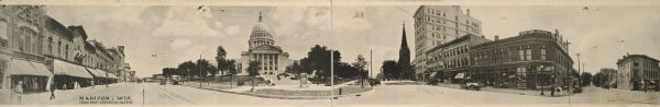 Panoramic view of Capitol Square, seen from the West corner. Originally functioned as an oversized post card. Identifiable businesses include Haswell Furniture Co., The Hub, and Menges Pharmacy.