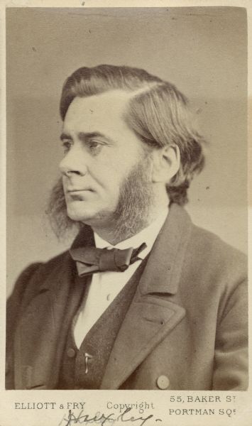 Carte-de-visite portrait of Thomas H. Huxley, an English biologist, known as "Darwin's Bulldog." He also coined the term "agnosticism" to describe his religious beliefs. Handwritten text at the bottom of the image reads: "Huxley."
